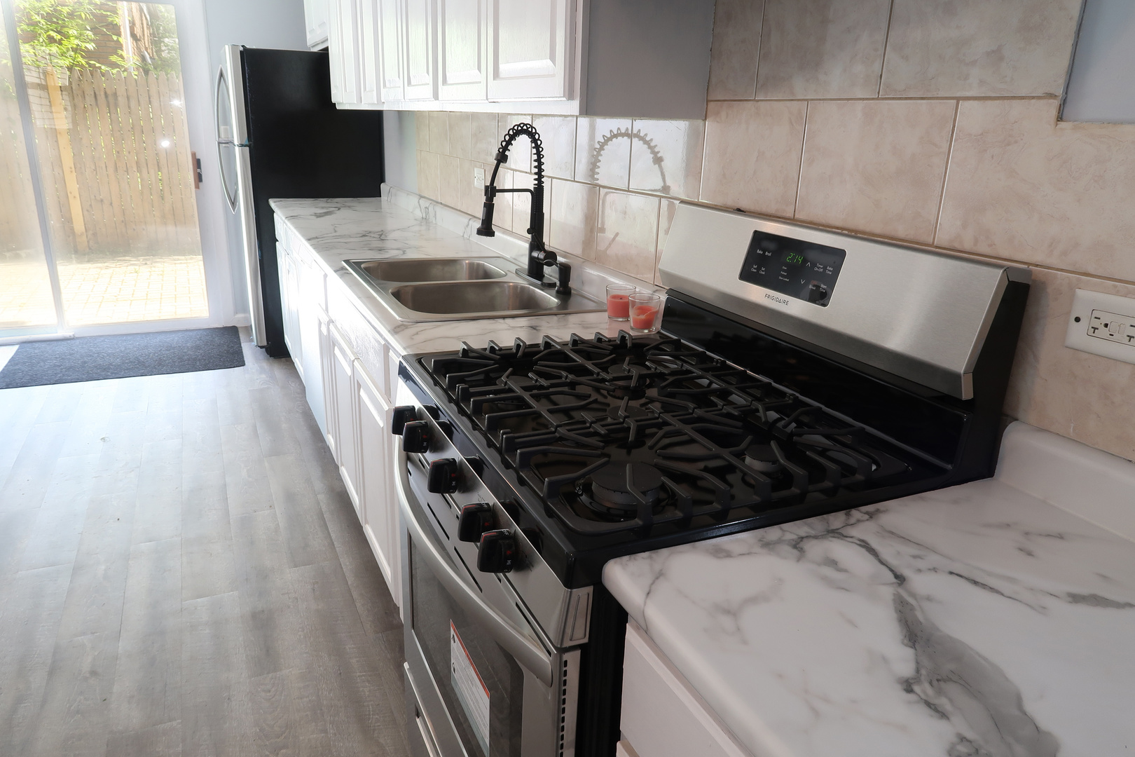 129 Kingston Road Bolingbrook, IL 60440 - Photo 16 of 37 a kitchen with a stove a sink and a refrigerator