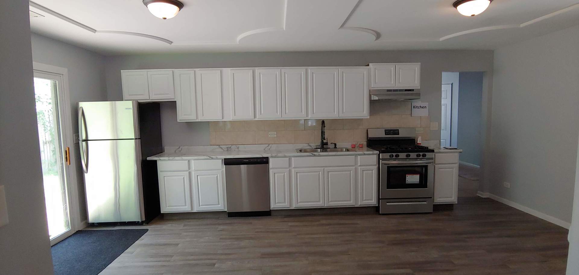 129 Kingston Road Bolingbrook, IL 60440 - Photo 18 of 37 a kitchen with a white cabinets and white appliances