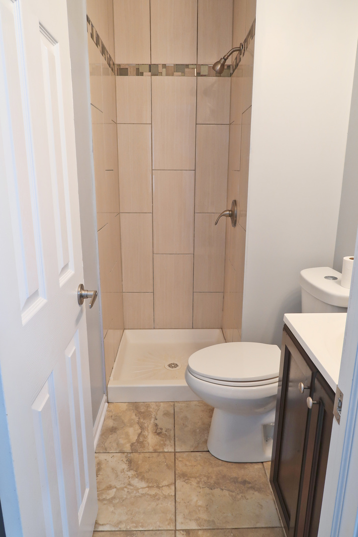 129 Kingston Road Bolingbrook, IL 60440 - Photo 27 of 37 a white toilet sitting next to a shower