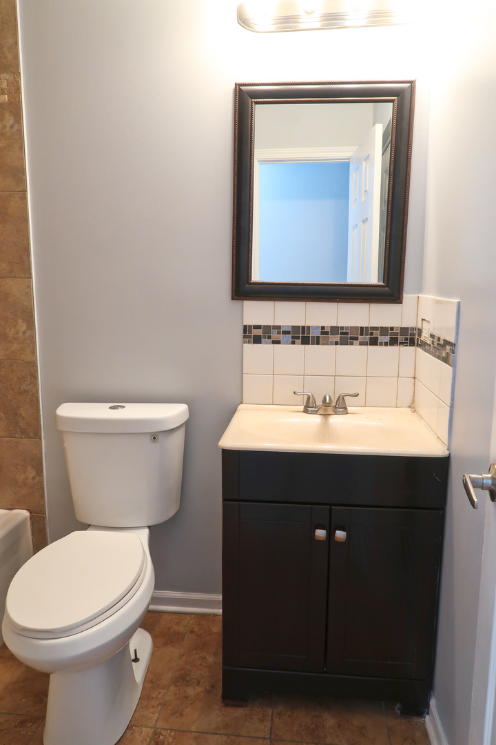 129 Kingston Road Bolingbrook, IL 60440 - Photo 32 of 37 a bathroom with a toilet sink and mirror