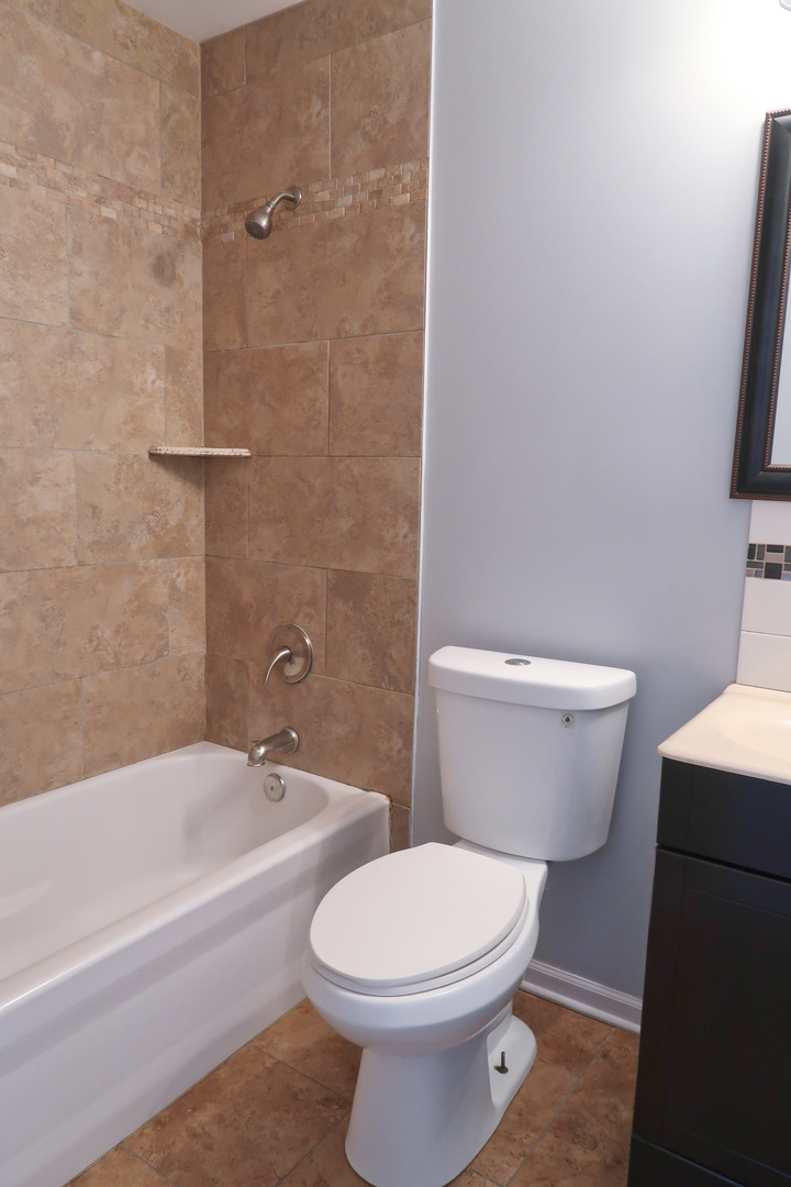 129 Kingston Road Bolingbrook, IL 60440 - Photo 33 of 37 a white toilet sitting next to a bath tub