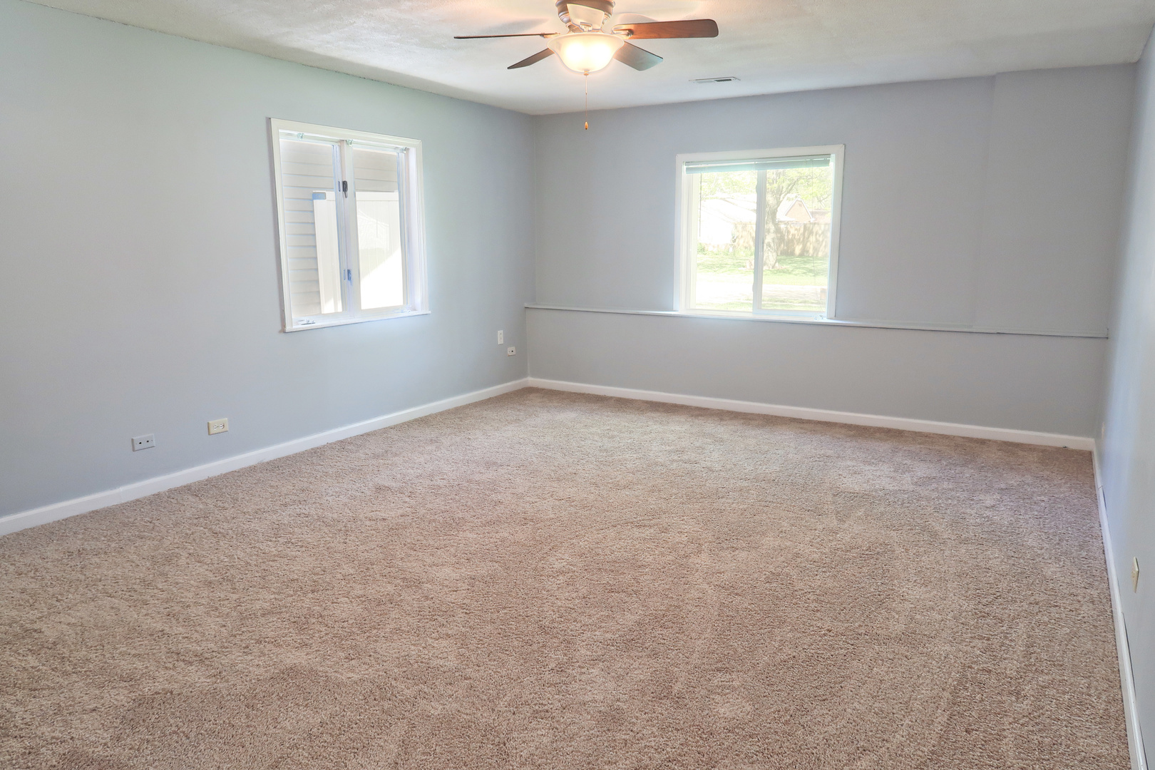 129 Kingston Road Bolingbrook, IL 60440 - Photo 8 of 37 an empty room with windows and chandelier fan