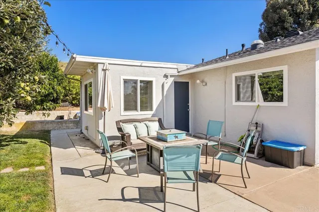 a view of a patio with table and chairs and potted plants