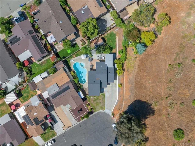 an aerial view of a house with a yard and garden