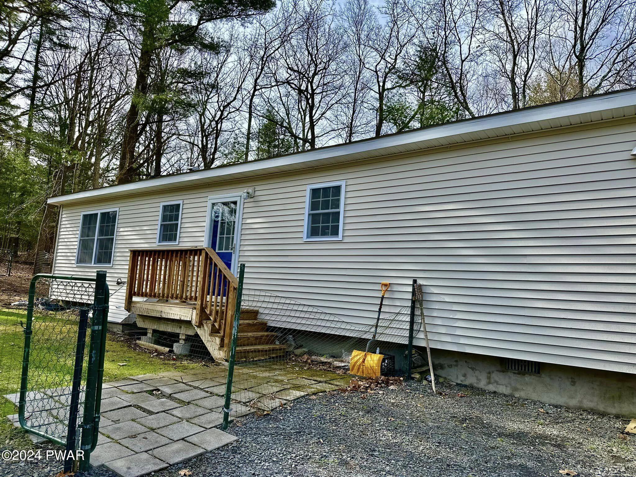 210 Fox Road Dingmans Ferry, PA 18328 - Photo 5 of 38 a view of a house with a yard and wooden fence