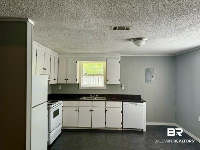 502 Forest Street Mobile, AL 36611 - Photo 3 of 10 Kitchen featuring sink, dark tile patterned floors, white appliances, and white cabinets