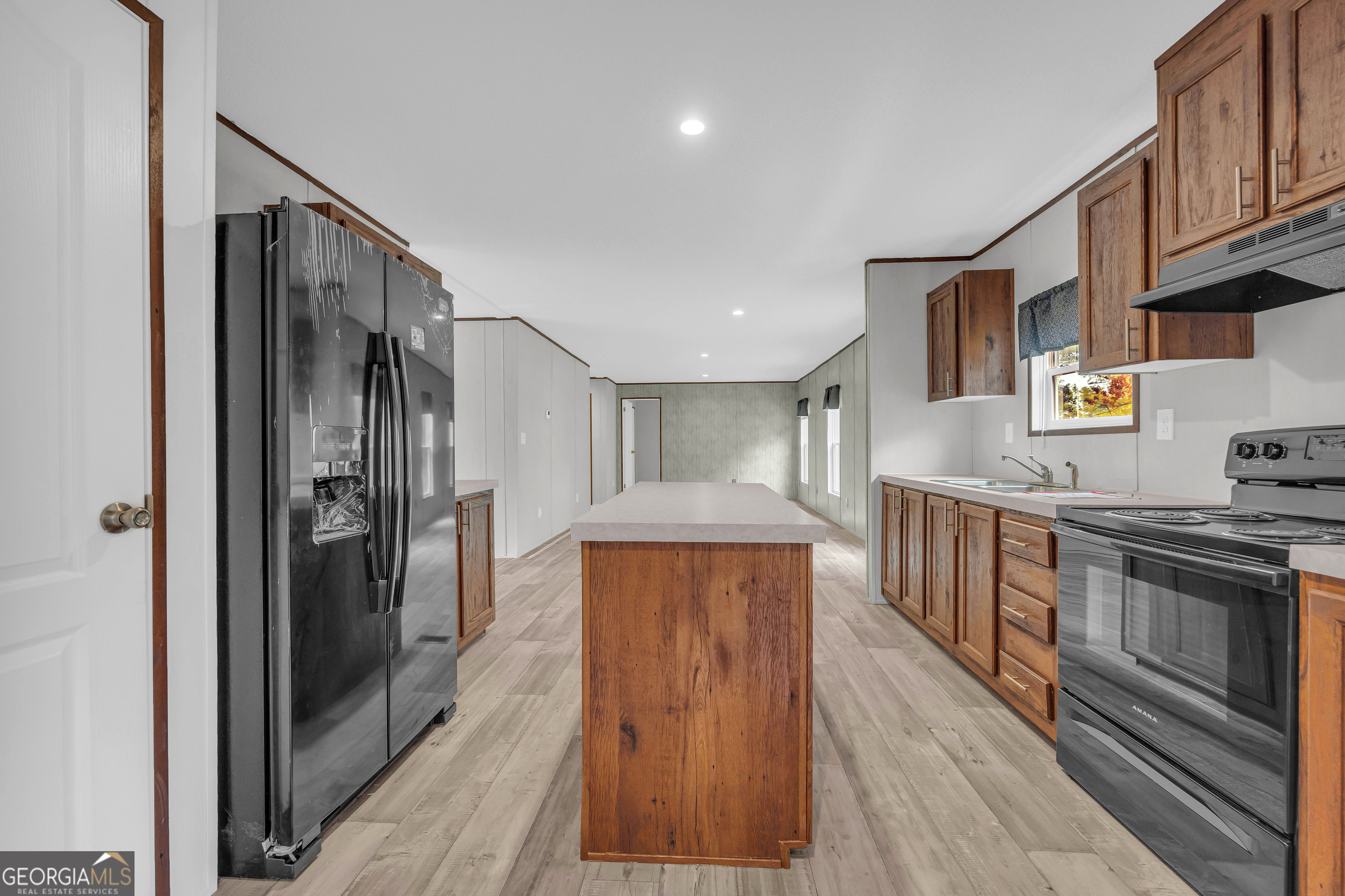 410 Wilson Cemetery Road Nicholson, GA 30565 - Photo 11 of 60 a kitchen with stainless steel appliances granite countertop a refrigerator a stove and a wooden floors