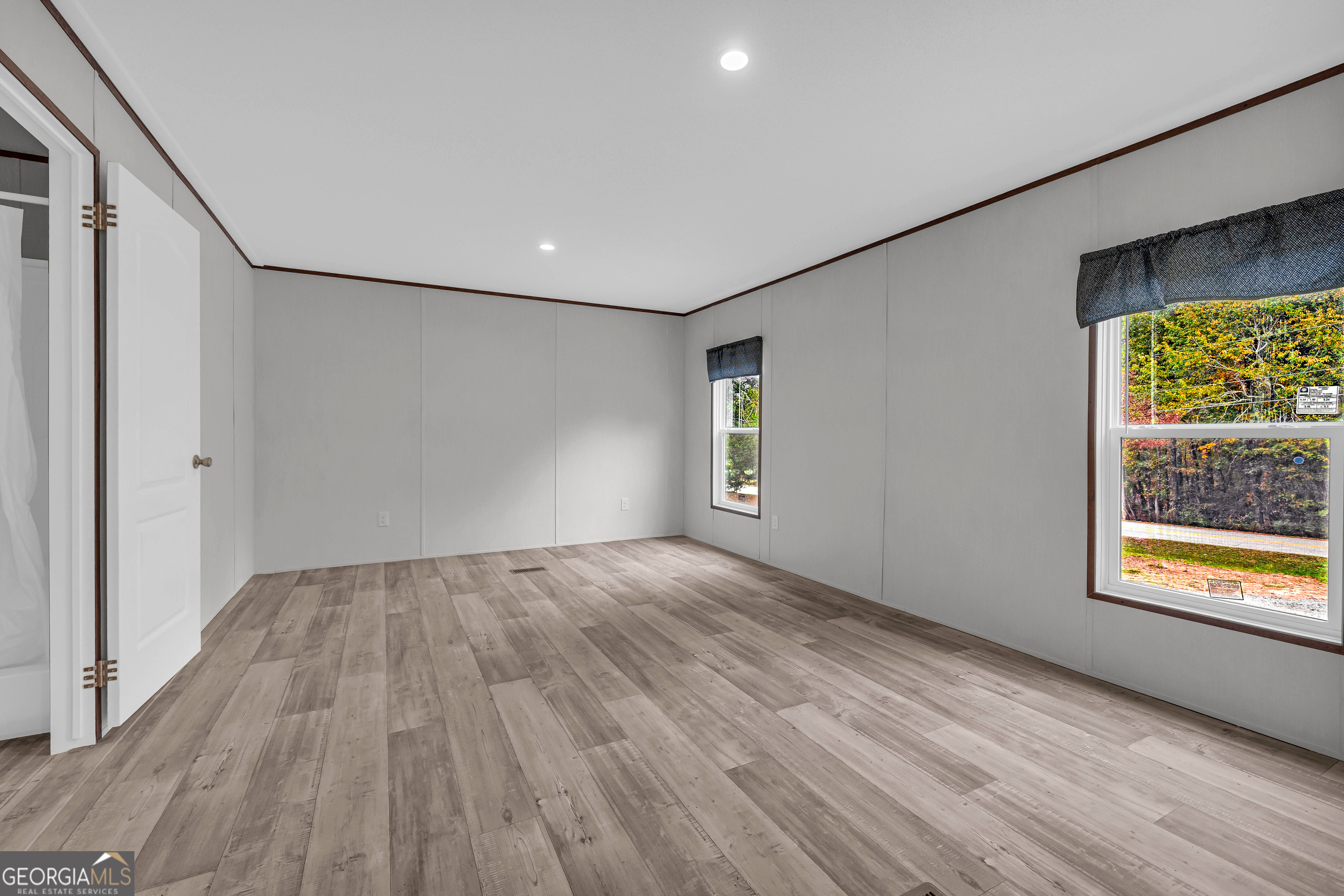 410 Wilson Cemetery Road Nicholson, GA 30565 - Photo 25 of 60 a view of an empty room with wooden floor and a window