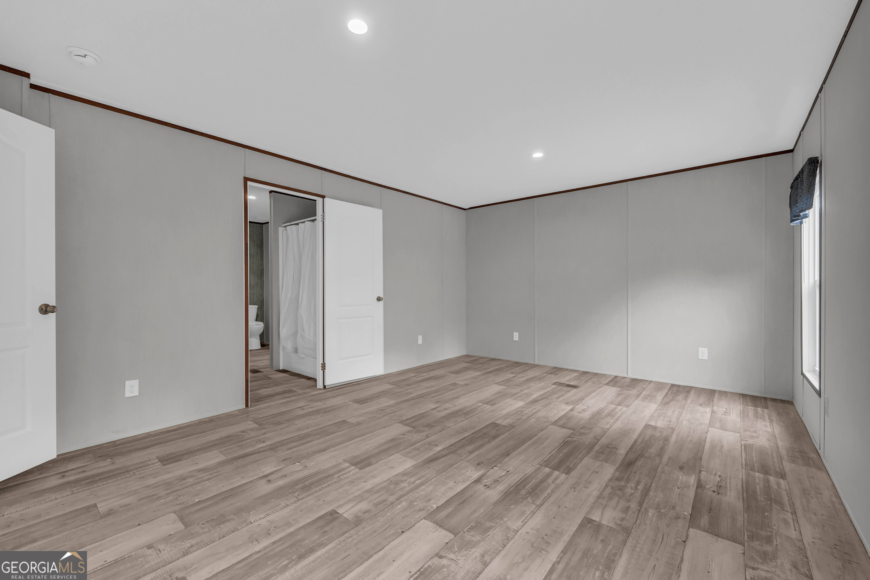 410 Wilson Cemetery Road Nicholson, GA 30565 - Photo 26 of 60 a view of an empty room with wooden floor