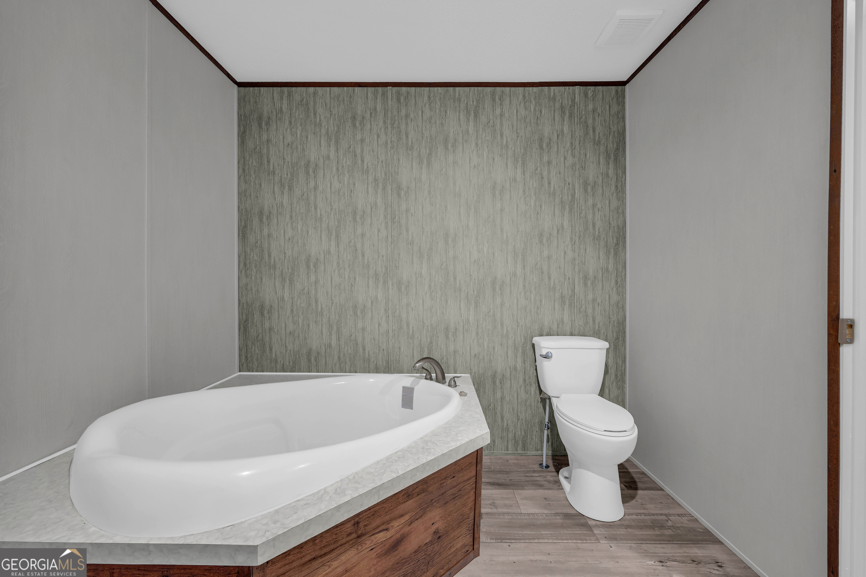 410 Wilson Cemetery Road Nicholson, GA 30565 - Photo 28 of 60 a white bath tub sitting next to a white toilet and a sink