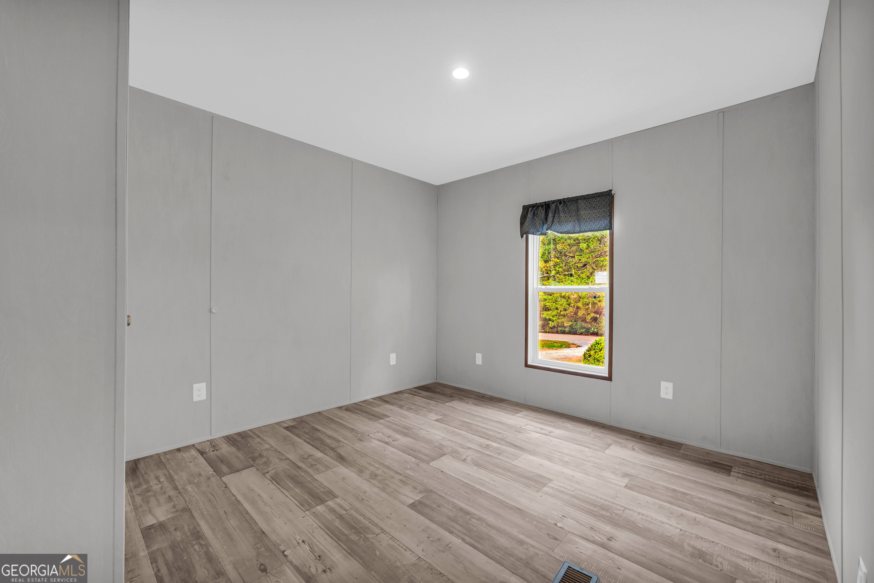 410 Wilson Cemetery Road Nicholson, GA 30565 - Photo 34 of 60 a view of an empty room with wooden floor and a window