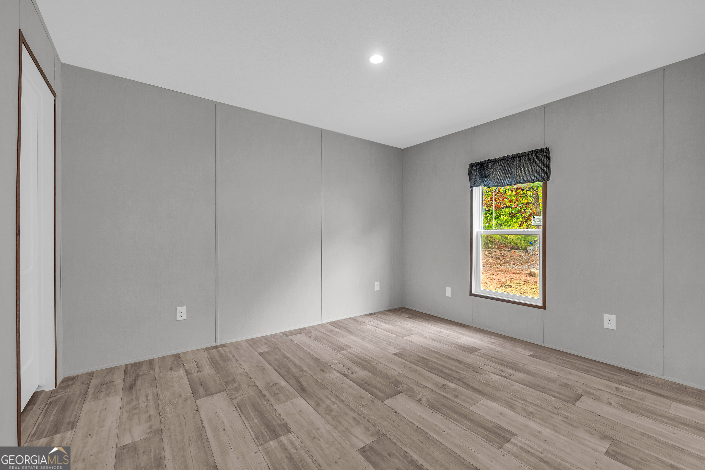410 Wilson Cemetery Road Nicholson, GA 30565 - Photo 36 of 60 a view of an empty room with wooden floor and a window