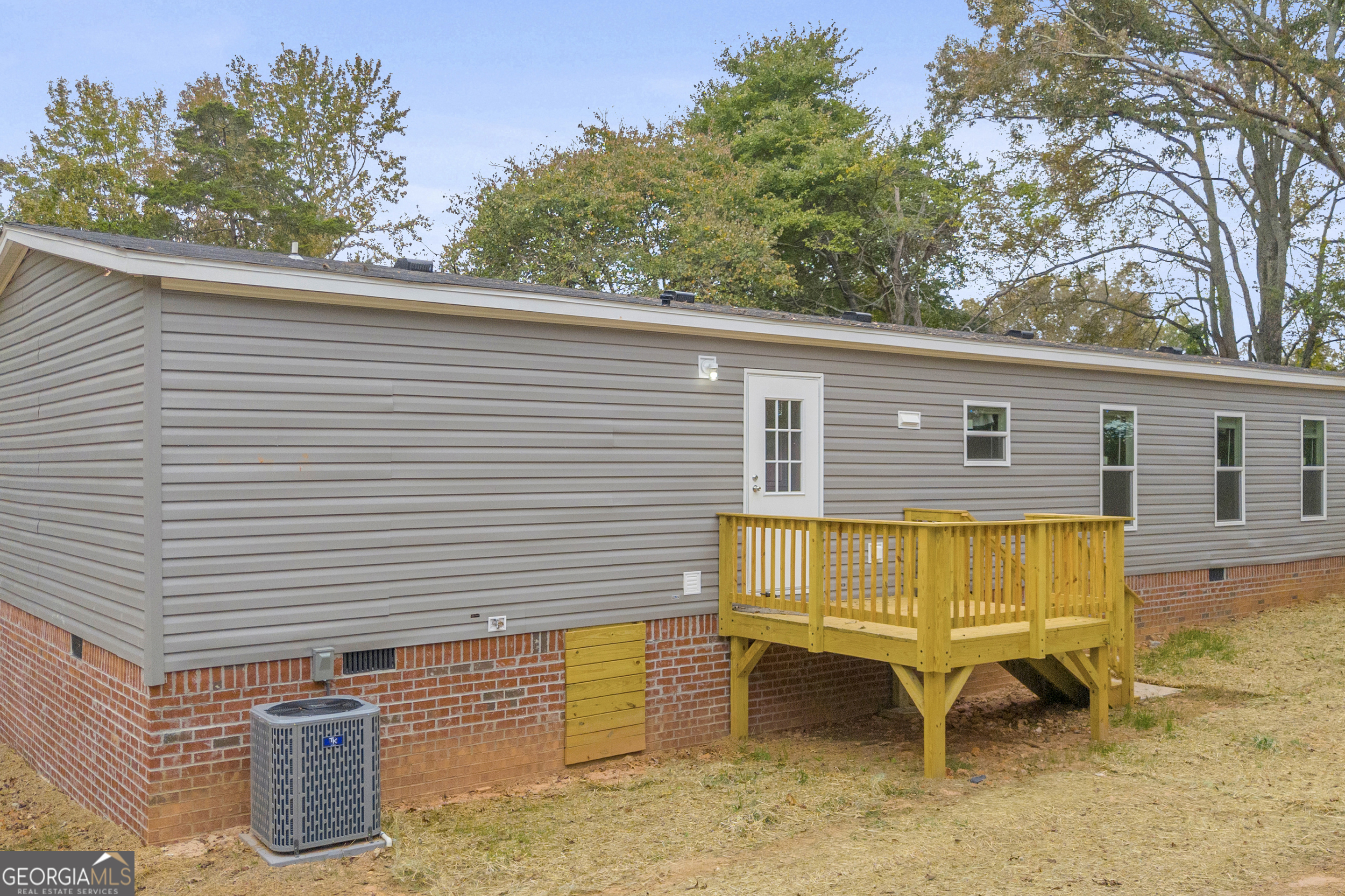410 Wilson Cemetery Road Nicholson, GA 30565 - Photo 7 of 60 a blue bench sitting in front of a house