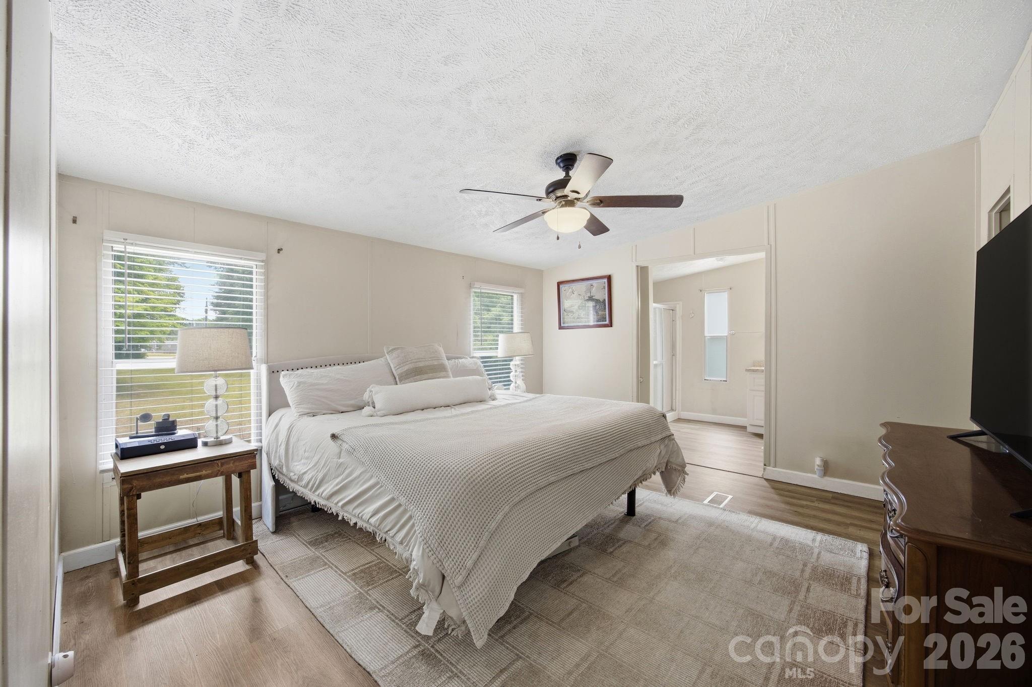 675 Overcash Road Salisbury, NC 28147 - Photo 24 of 48 a bedroom with a bed and a chandelier