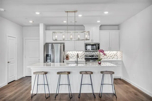 a kitchen with kitchen island granite countertop a table and chairs