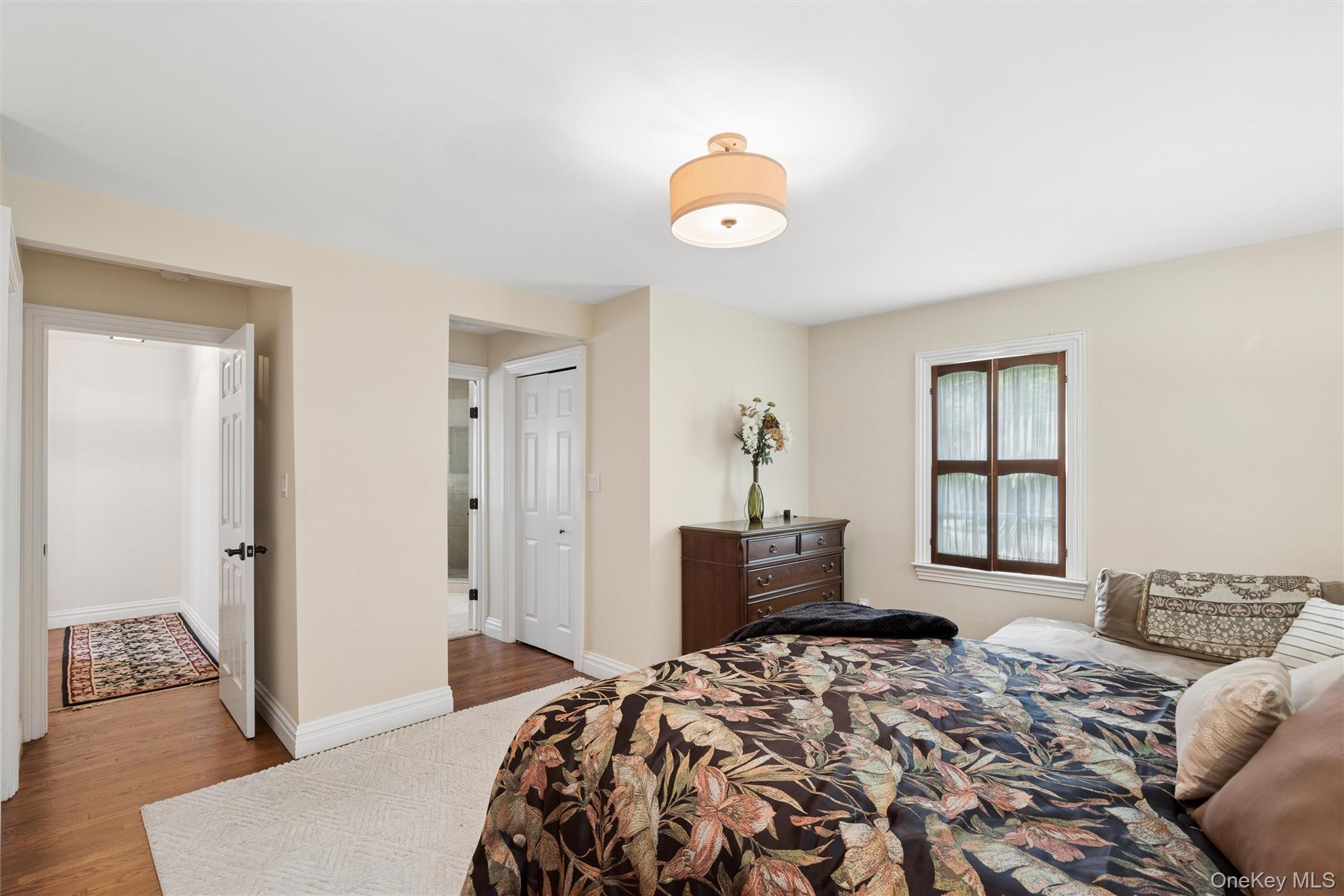50 Belton Road Babylon, NY 11702 - Photo 20 of 34 lst floor primary bedroom is 17.5 ft x 17.3 ft and has hardwood floors and custom closets plus access to a private master bath.