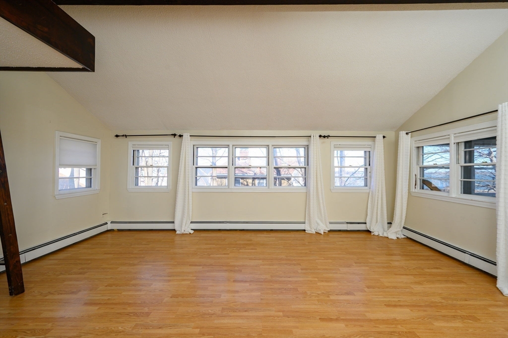81 Kimball Beach Road Hingham, MA 02043 - Photo 11 of 29 a view of an empty room with window and wooden floor