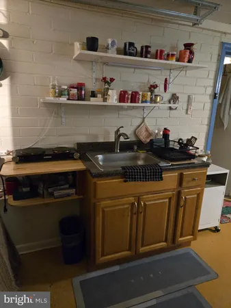 a kitchen with stainless steel appliances a stove sink microwave and cabinets
