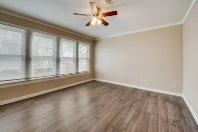 wooden floor in an empty room with a window