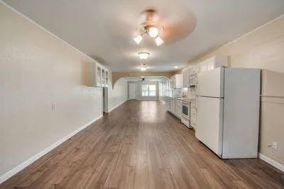 a view of a refrigerator in kitchen and wooden floor