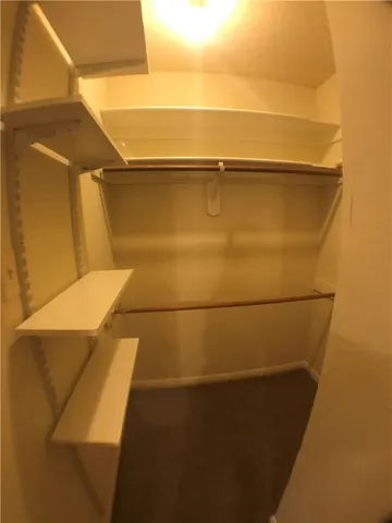 a view of a closet with wooden floor