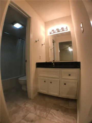a bathroom with a sink a toilet and mirror