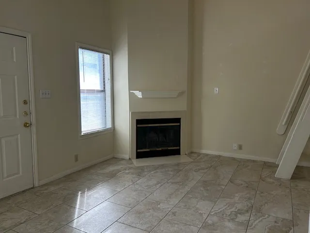 an empty room with a fireplace