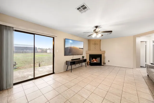 a view of a livingroom with a fireplace and a chandelier