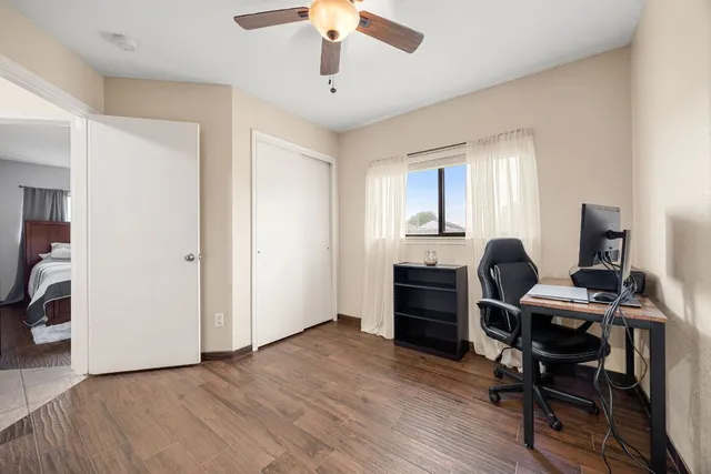 a view of a workspace with furniture and a window