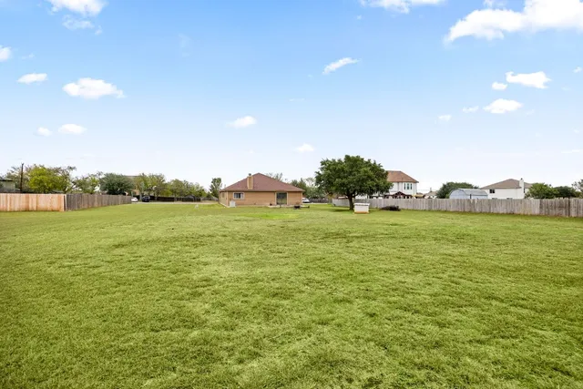a view of a field with an ocean