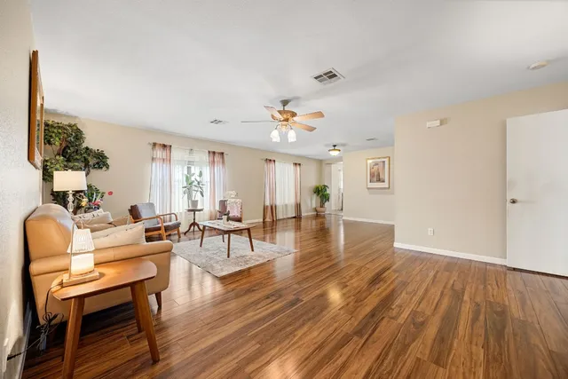 a living room with furniture and wooden floor