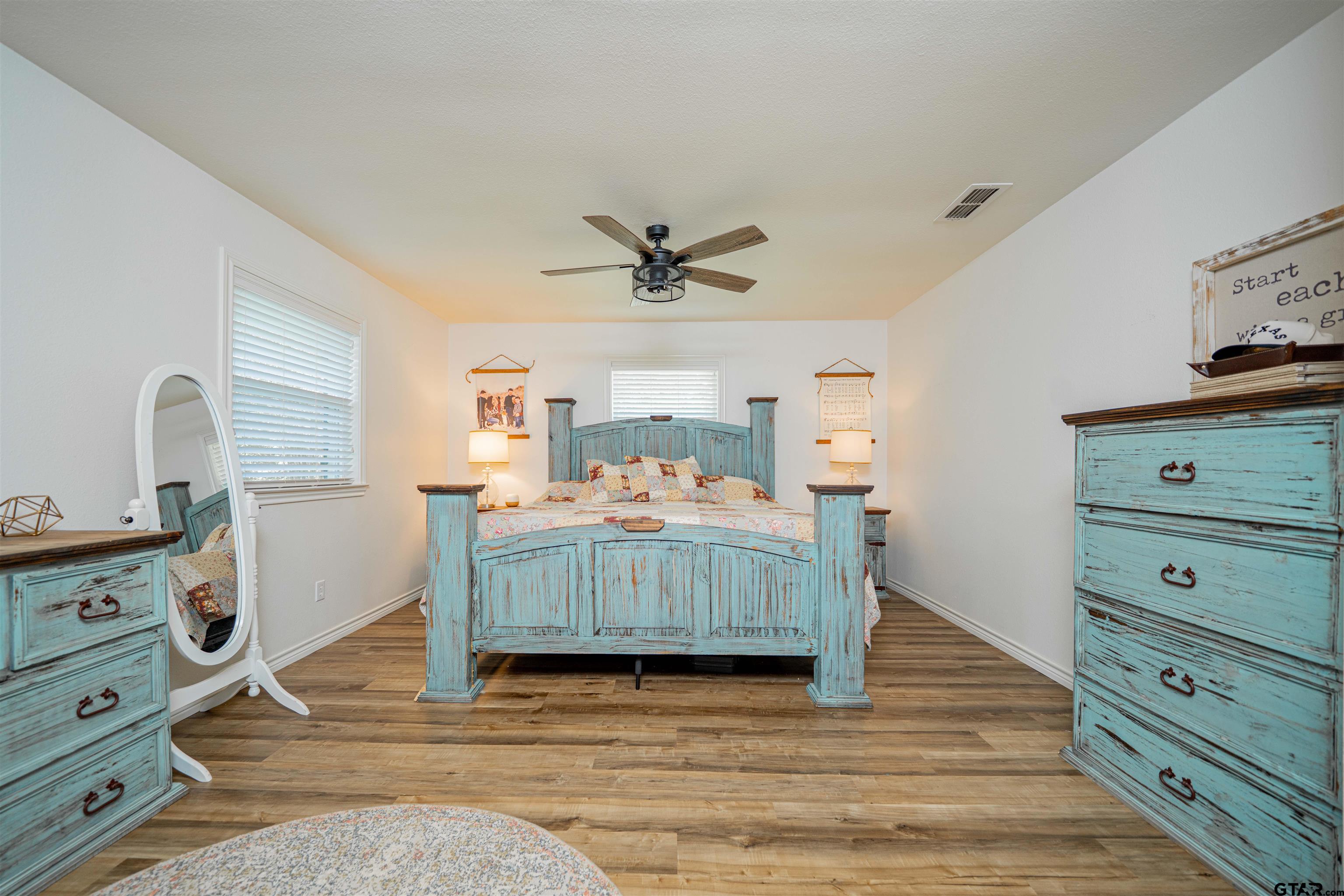 400 Crestview Hughes Springs, TX 75656 - Photo 12 of 32 a bedroom with a bed and a ceiling fan