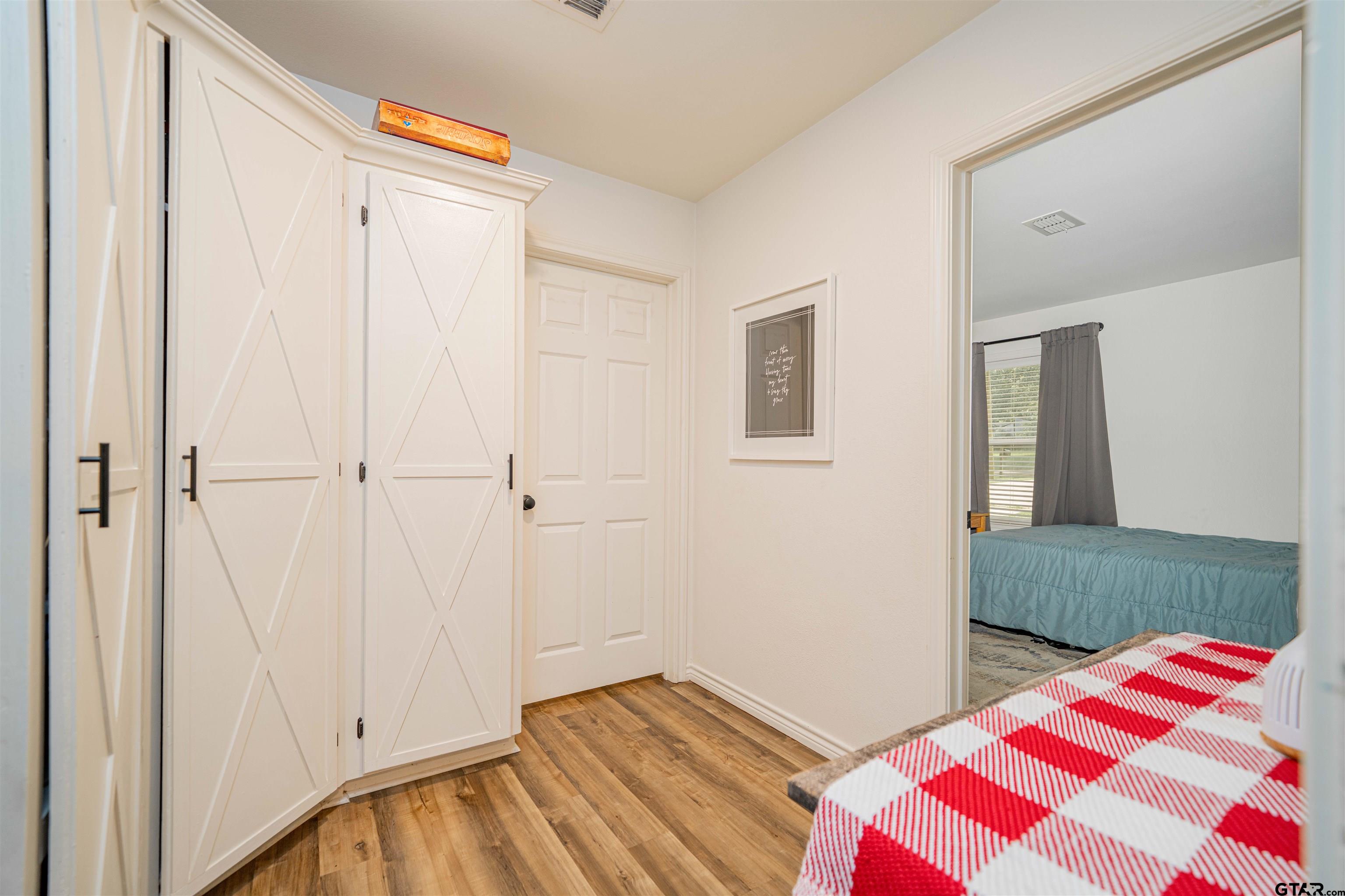 400 Crestview Hughes Springs, TX 75656 - Photo 18 of 32 a bedroom with a bed and a mirror