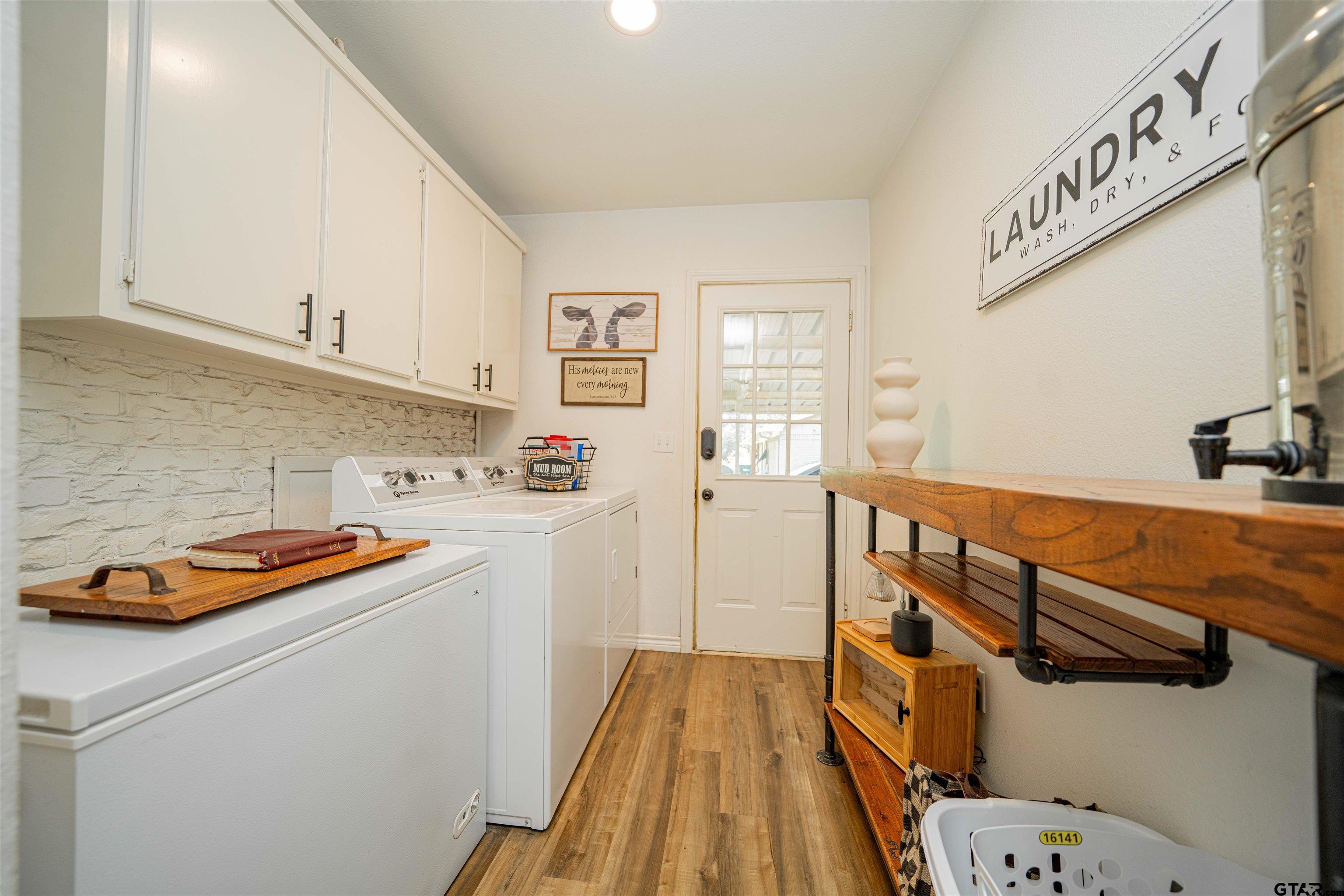 400 Crestview Hughes Springs, TX 75656 - Photo 24 of 32 a kitchen with a sink a stove and cabinets