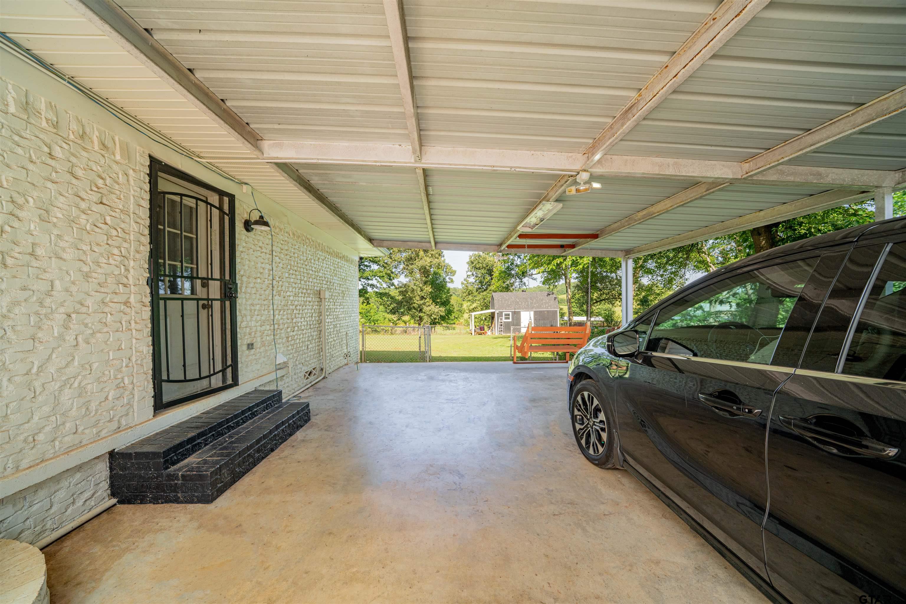 400 Crestview Hughes Springs, TX 75656 - Photo 30 of 32 a view of a backyard with sitting area