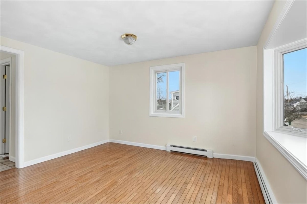 27 Packard Avenue Hull, MA 02045 - Photo 11 of 30 a view of a room with wooden floor and window
