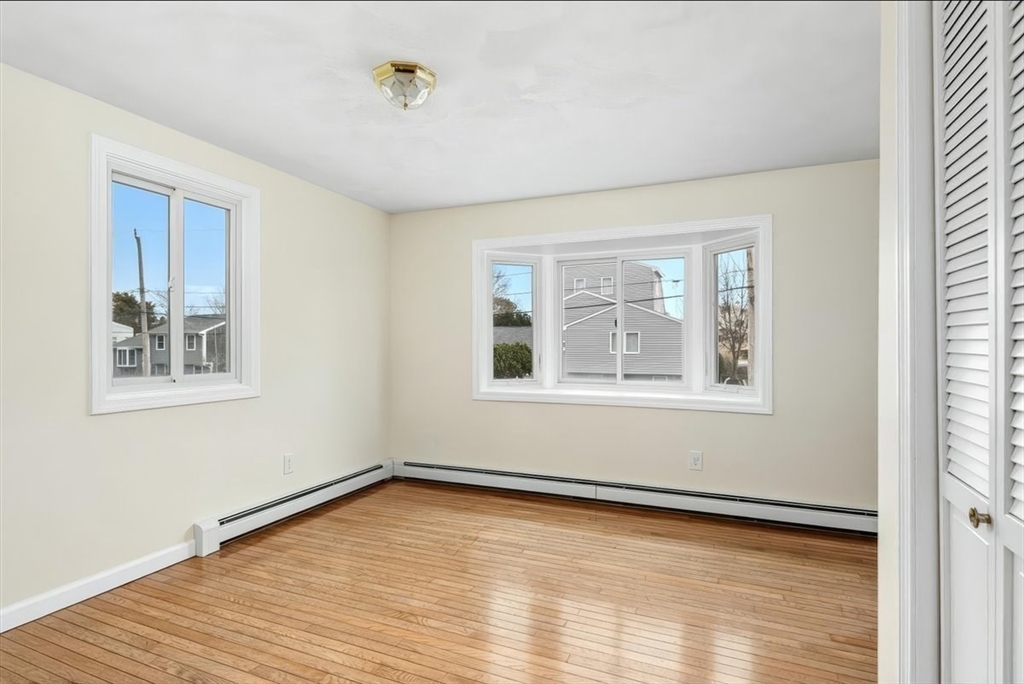 27 Packard Avenue Hull, MA 02045 - Photo 12 of 30 a view of an empty room with wooden floor and a window