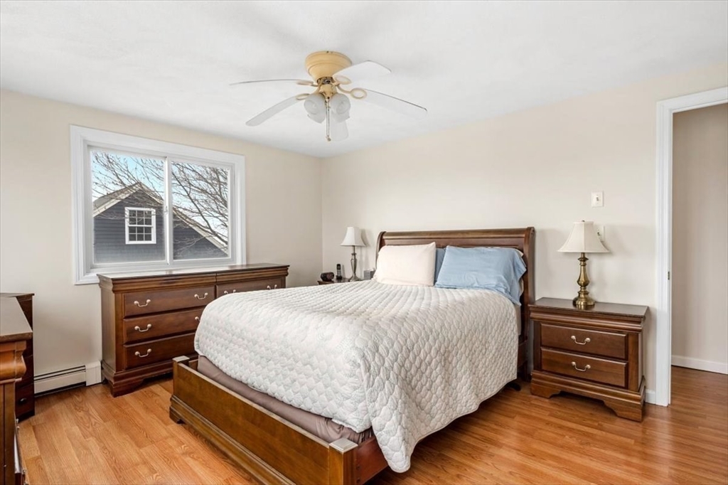 27 Packard Avenue Hull, MA 02045 - Photo 17 of 30 a bedroom with a bed and wooden floor