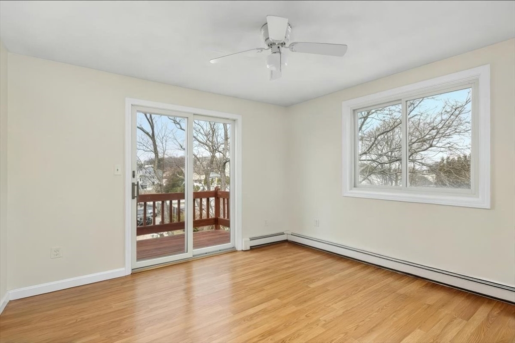 27 Packard Avenue Hull, MA 02045 - Photo 20 of 30 an empty room with wooden floor and windows