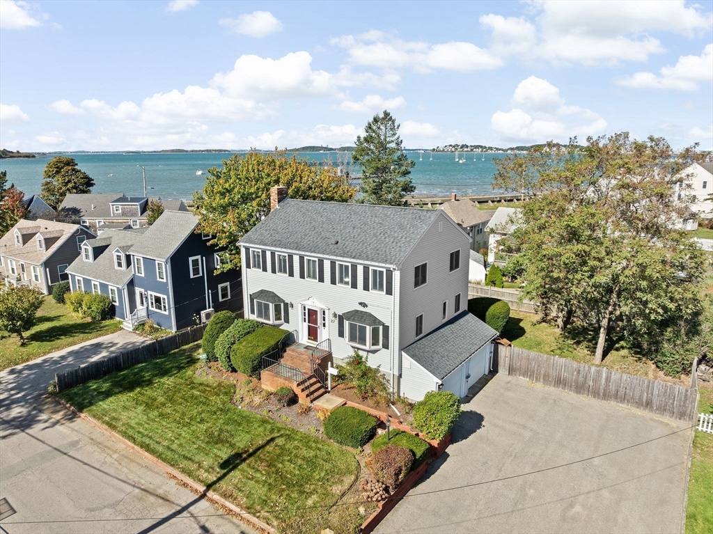 27 Packard Avenue Hull, MA 02045 - Photo 2 of 30 a front view of a house with a garden