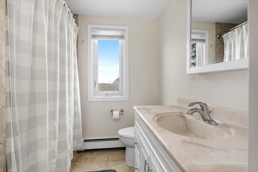 27 Packard Avenue Hull, MA 02045 - Photo 23 of 30 a bathroom with a sink and a toilet