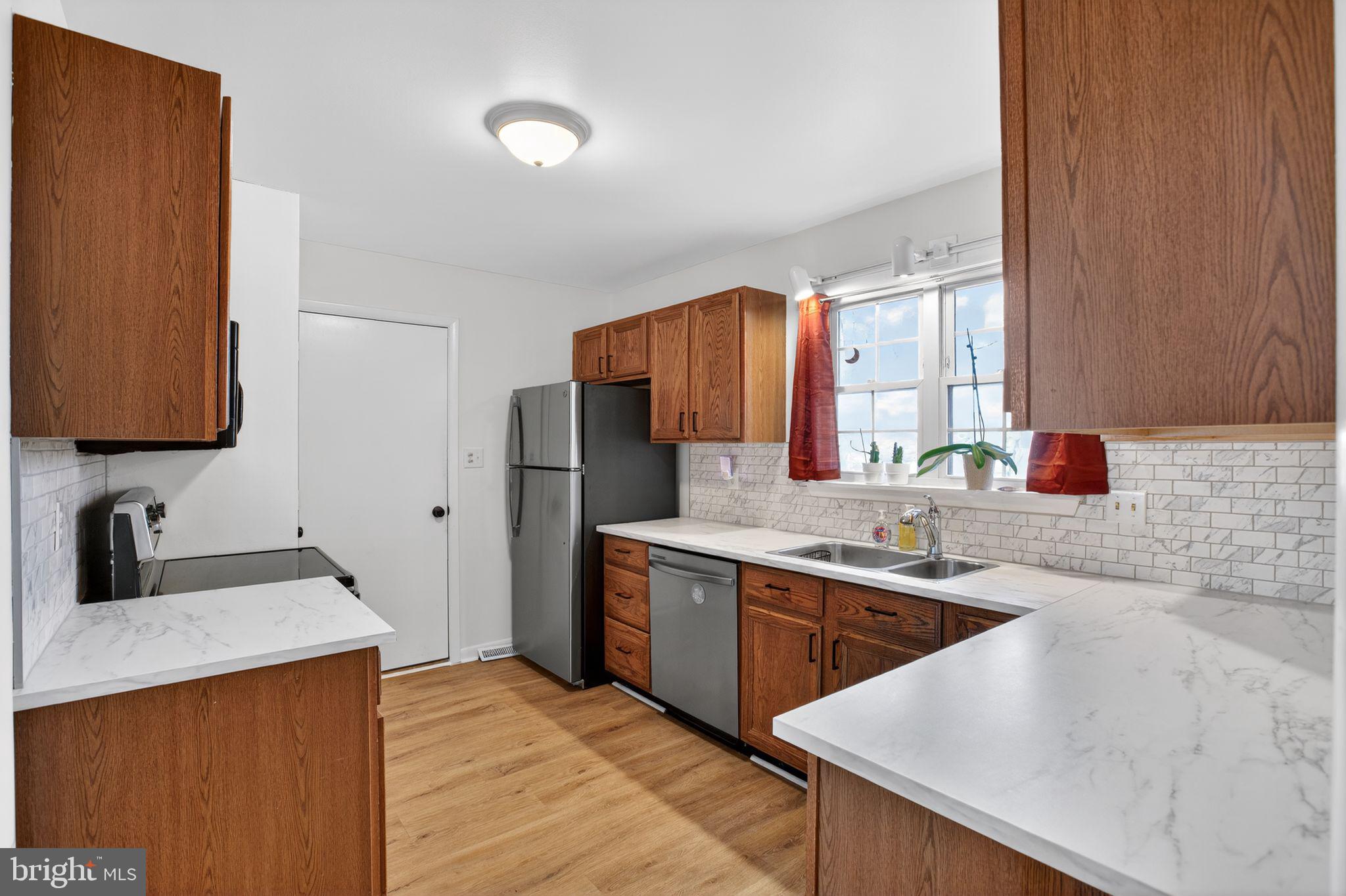 21620 Defender Street Lexington Park, MD 20653 - Photo 19 of 49 a kitchen with a sink cabinets and window