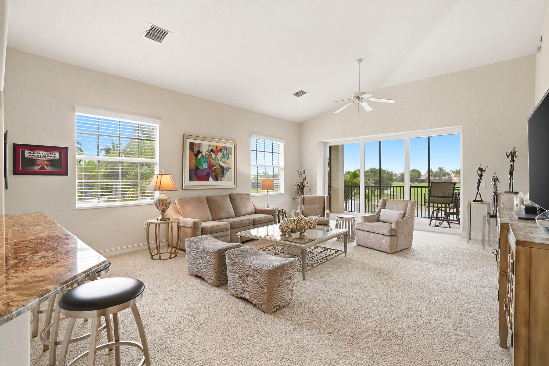8605 Champions Point, Unit 103 Naples, FL 34113 - Photo 16 of 44 a living room with furniture and a large window