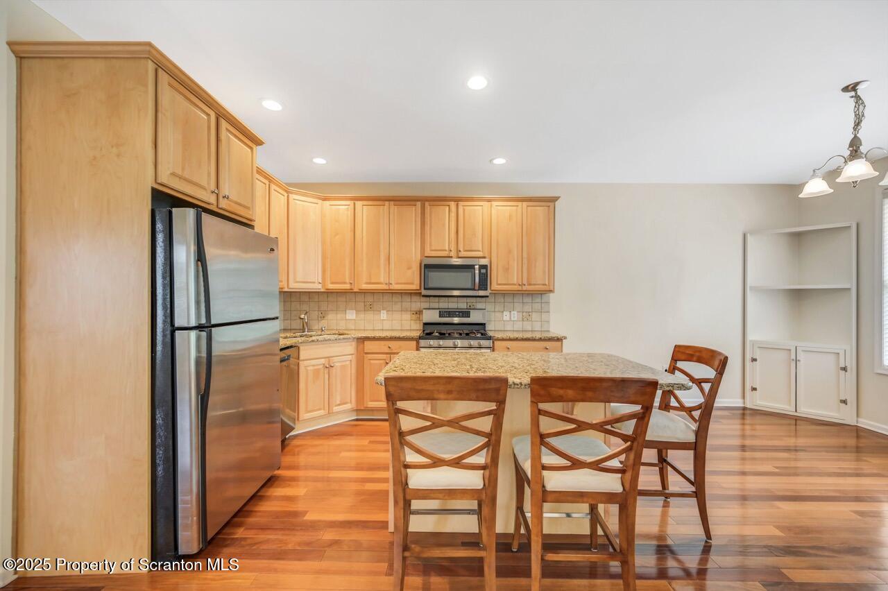2303 Browning Cl Moosic, PA 18507 - Photo 14 of 71 a kitchen with stainless steel appliances granite countertop a refrigerator and wooden cabinets