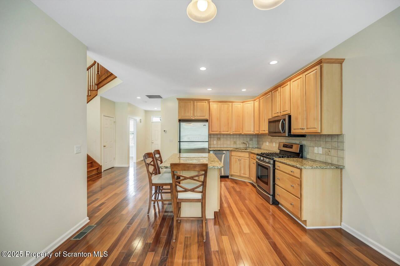 2303 Browning Cl Moosic, PA 18507 - Photo 17 of 71 a kitchen with stainless steel appliances granite countertop sink stove top oven and cabinets