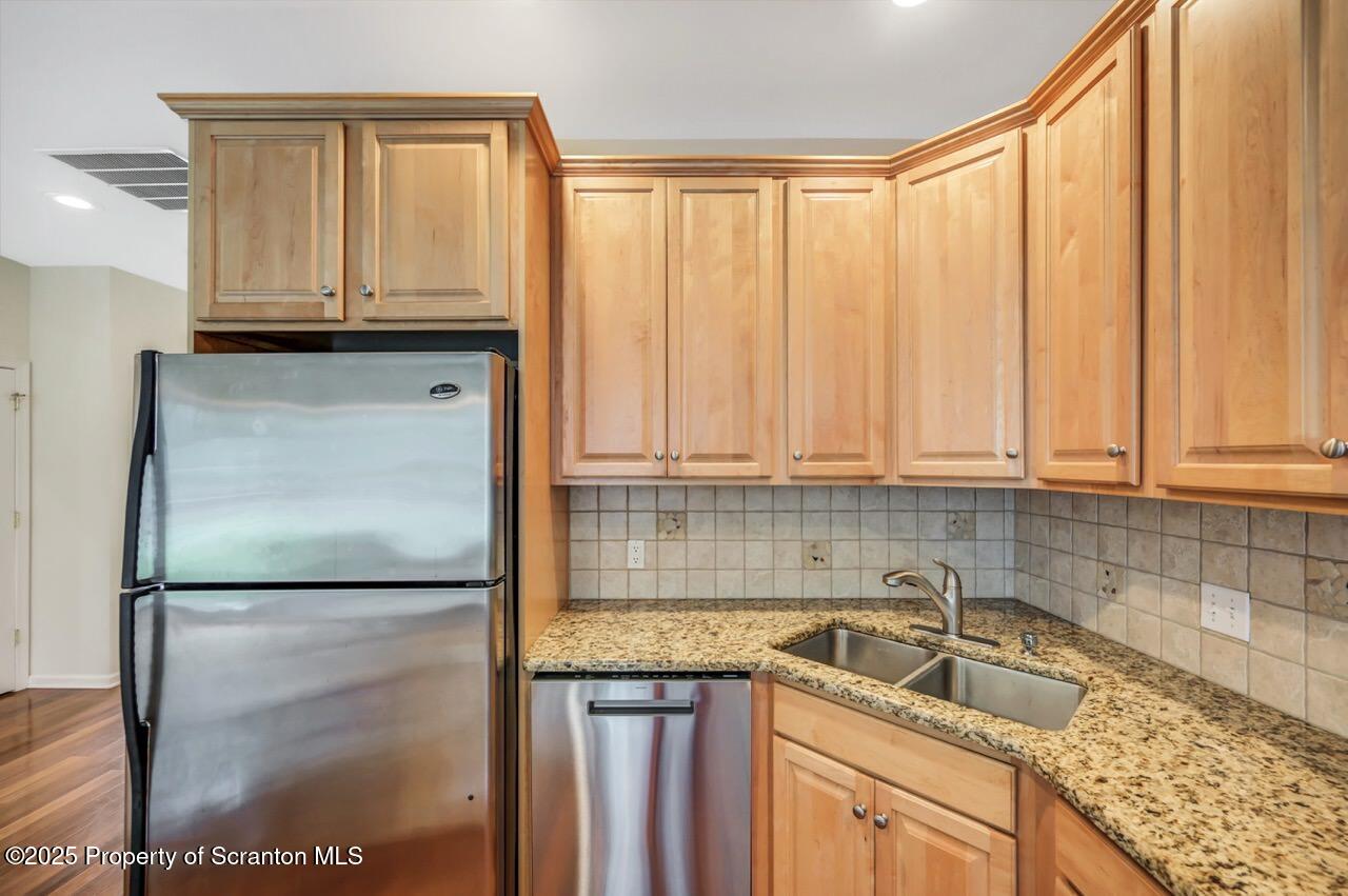 2303 Browning Cl Moosic, PA 18507 - Photo 21 of 71 a kitchen with a sink a refrigerator and cabinets