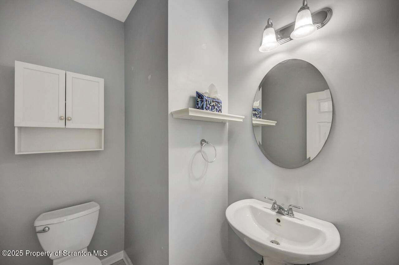 2303 Browning Cl Moosic, PA 18507 - Photo 27 of 71 a bathroom with a toilet a sink and mirror
