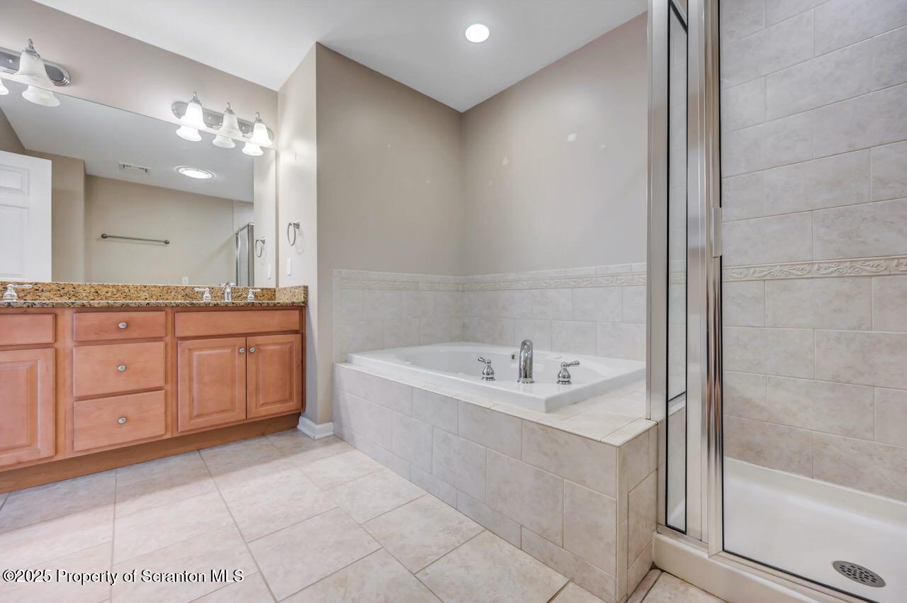 2303 Browning Cl Moosic, PA 18507 - Photo 41 of 71 a spacious bathroom with a mirror a sink and a bathtub