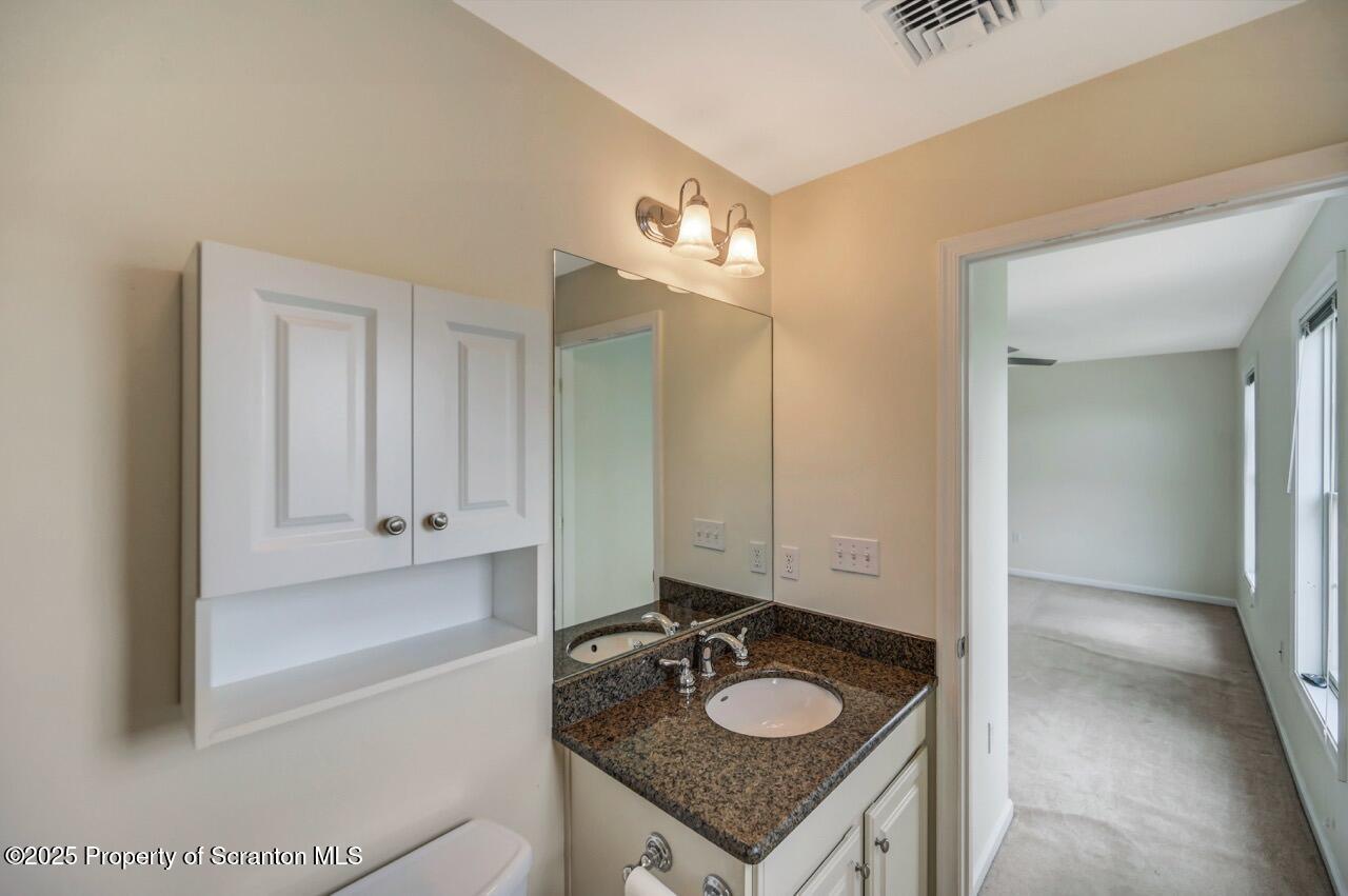 2303 Browning Cl Moosic, PA 18507 - Photo 49 of 71 a bathroom with a granite countertop sink and a mirror