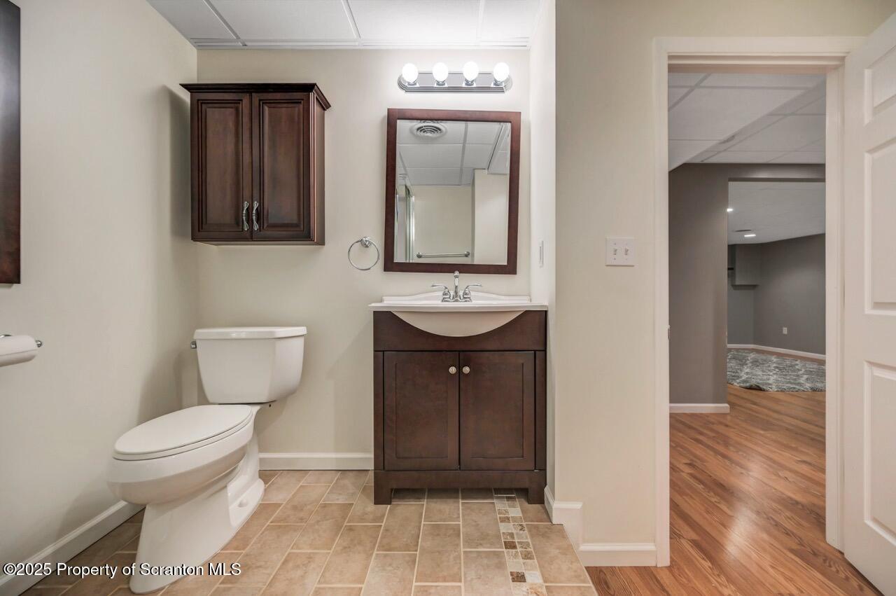 2303 Browning Cl Moosic, PA 18507 - Photo 61 of 71 a bathroom with a toilet a sink and mirror